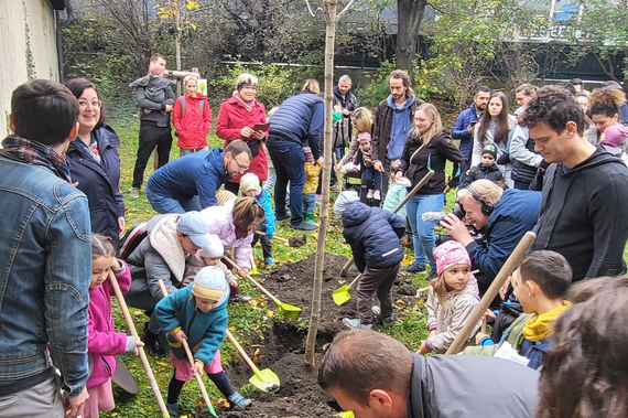 viele Kinder und Erwachsene graben mit Schaufeln